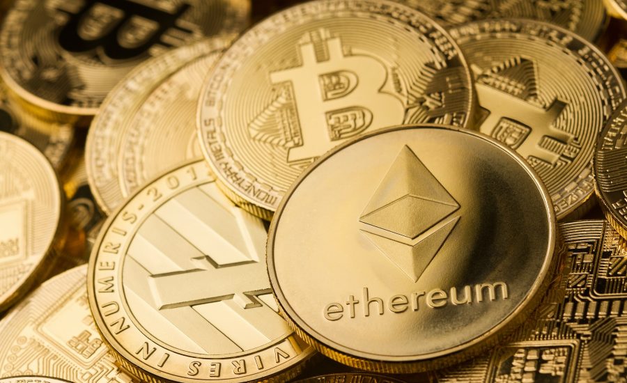 close up of ethereum litecoin and bitcoin stack of golden coins